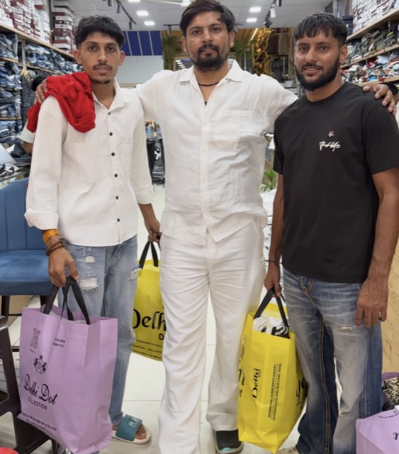 Three customers with Delhi·Dot·Collection shopping bags inside the Tohana store