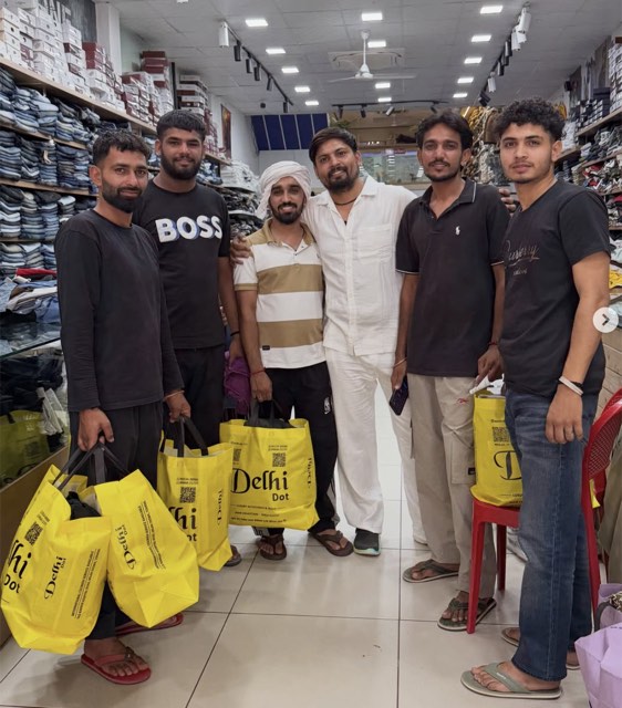 A group of customers with Delhi·Dot·Collection bags inside the Tohana store
